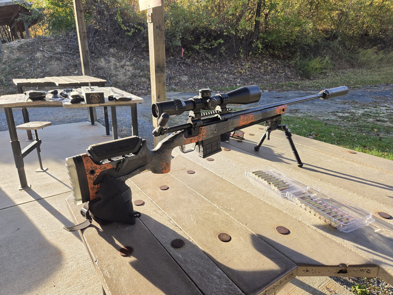 Grayboe Core stock rifle with scope and suppressor on a shooting bench at the range